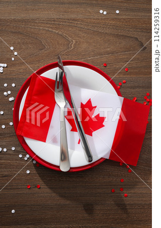 Cutlery with flag of Canada on wooden background 114259316