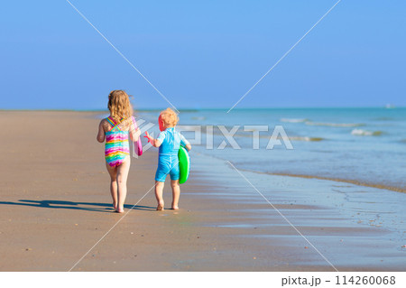 Kids playing on beach. Children play at sea. Kids playing on beach. Children play at sea. 114260068