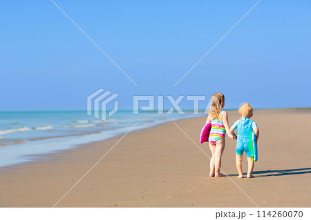 Kids playing on beach. Children play at sea. Kids playing on beach. Children play at sea. 114260070
