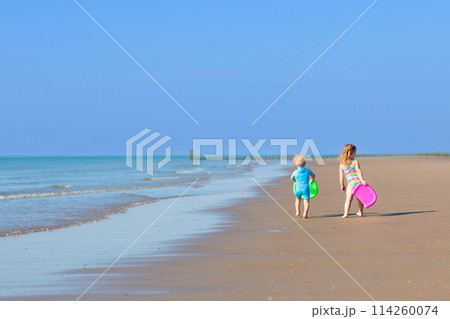 Kids playing on beach. Children play at sea. 114260074