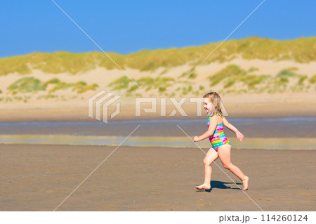 Kids playing on beach. Children play at sea. Kids playing on beach. Children play at sea. 114260124