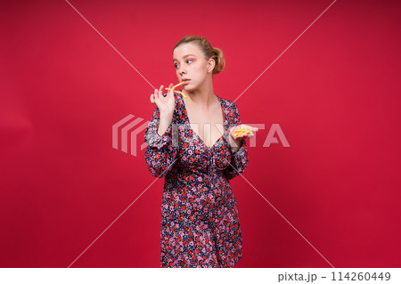 Unhealthy eating. Junk food concept. Portrait of fashionable young woman holding fried potato 114260449