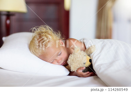 Baby boy sleeping in white bed 114260549