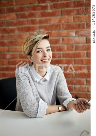positive blond female secretary at the table 114262678