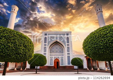courtyard of the new white uzbek Islamic Masjid Minor Mosque in Tashkent in Uzbekistan on background of orange sunset sky in summer 114262694