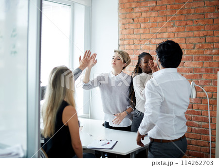 We've done it cheerful business people giving high-five We've done it cheerful business people giving high-five 114262703