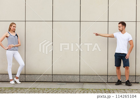 Man point finger at girl. Man point finger at girl. 114265104