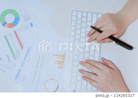 work and learn online in new normal concept from woman typing on wireless keyboard with business document and white isolated background 114265327