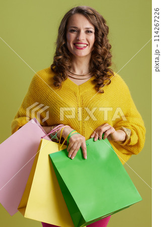 happy modern female isolated on green background 114267226