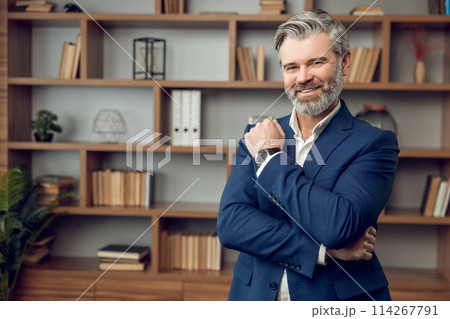 Friendly middle aged man psychotherapist wearing formal wear posing and smiling Friendly middle aged man psychotherapist wearing formal wear posing and smiling 114267791