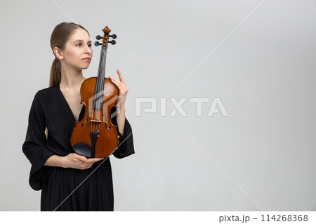 Woman professional violist playing musical instrument Woman professional violist playing musical instrument 114268368