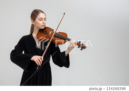 Woman musical artist playing violin Woman musical artist playing violin 114268396