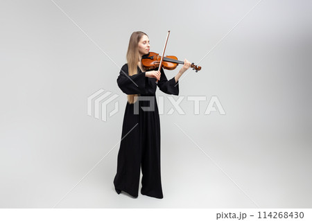 Full length portrait of attractive woman musician playing violin Full length portrait of attractive woman musician playing violin 114268430
