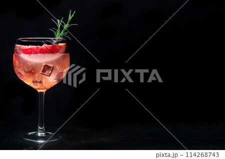 Fancy cocktail with fresh fruit. Gin and tonic drink with ice at a party 114268743
