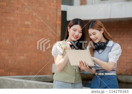 Asian young campus student enjoy learn study and reading books together. Friendship and Education concept. Campus and university Asian young campus student enjoy learn study and reading books together. Friendship and Education concept. Campus and university 114270163