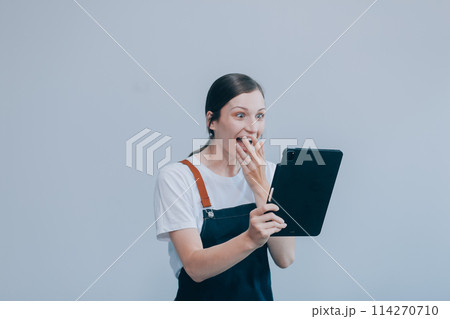 .Cheerful beautiful Asian woman wearing jeans overalls with excited doing winner gesture with arms raised isolated on white background. .Cheerful beautiful Asian woman wearing jeans overalls with excited doing winner gesture with arms raised isolated on white background. 114270710