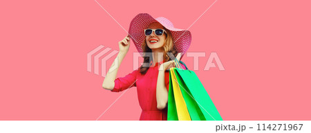 Beautiful happy smiling young woman model posing with shopping bags in summer hat Beautiful happy smiling young woman model posing with shopping bags in summer hat 114271967