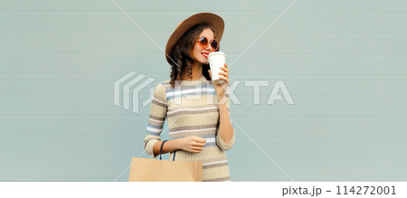 Stylish beautiful happy smiling young woman posing with shopping bags on city street Stylish beautiful happy smiling young woman posing with shopping bags on city street 114272001