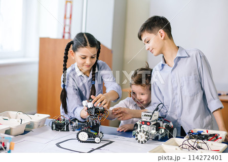 Two children, brother with sister enaging in their hobby-constructing robot toys 114272401
