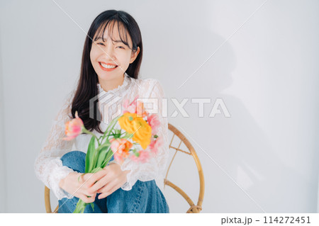 椅子に座って花束を持つ女性　　 114272451