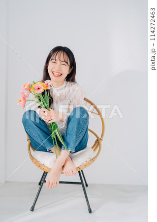 椅子に座って花束を持つ女性 椅子に座って花束を持つ女性 114272463