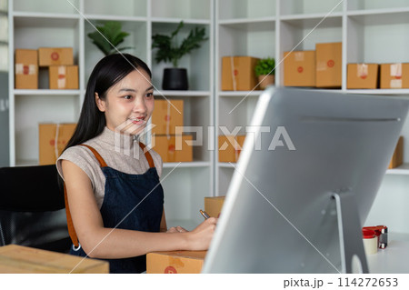 Woman asian in an online store check the customer address and package information on box. Online shopping concept Woman asian in an online store check the customer address and package information on box. Online shopping concept 114272653