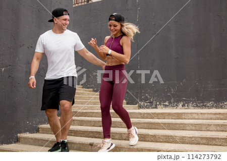 Couple running on stairs in morning, jogging in urban area with starecases. Couple running on stairs in morning, jogging in urban area with starecases. 114273792