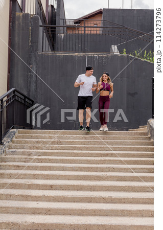 Couple running on stairs in morning, jogging in urban area with starecases. 114273796