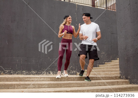 Couple running on stairs in morning, jogging in urban area with starecases. Couple running on stairs in morning, jogging in urban area with starecases. 114273936
