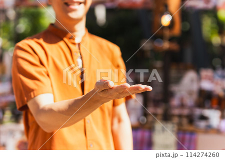 Happy man with open hand inviting to enter with smiling. 114274260