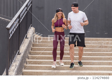 Couple running on stairs in morning, jogging in urban area with starecases. 114274660