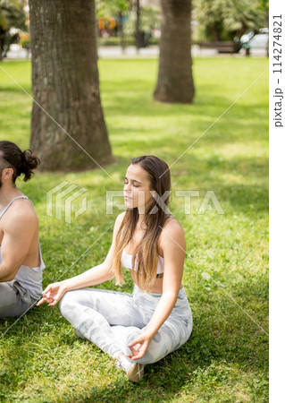 Young couple doing yoga outdoors 114274821