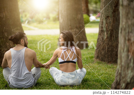 Young couple doing yoga outdoors 114274822