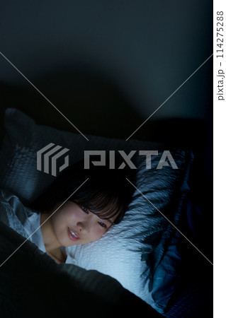 ベッドで自分時間を過ごす若い女性 ベッドで自分時間を過ごす若い女性 114275288