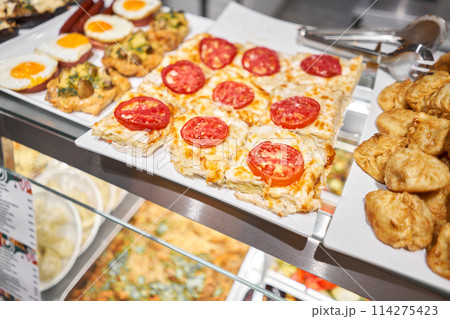 Various hot dishes . Glass Showcase in a buffet or self-service restaurant. 114275423