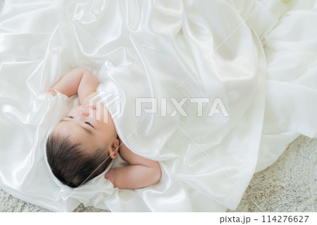 白い布に包まれて寝ている赤ちゃん 白い布に包まれて寝ている赤ちゃん 114276627