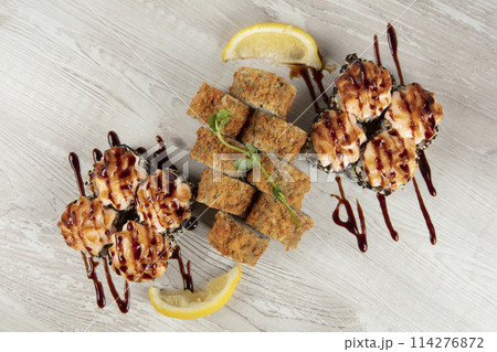Set of various sushi rolls on a white wooden background. Japanese food. Set of various sushi rolls on a white wooden background. Japanese food. 114276872