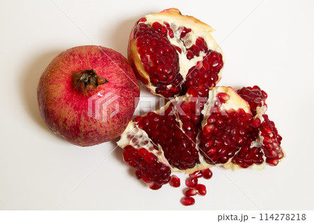 Purified pomegranate fruit on a white background Purified pomegranate fruit on a white background 114278218