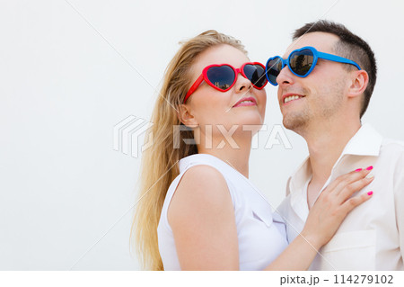 Man and woman wearing heart shape sunglasses 114279102