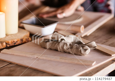 a piece of clay on the table on the workshop a piece of clay on the table on the workshop 114279487