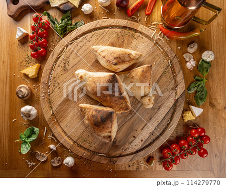 Rustic homemade calzones Rustic homemade calzones 114279770