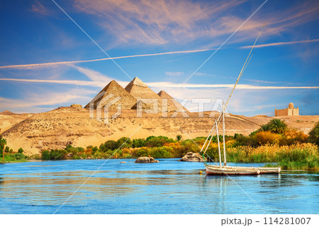 View on the Nile and the boats in the Aswan desert by the pyramids, Egypt View on the Nile and the boats in the Aswan desert by the pyramids, Egypt 114281007