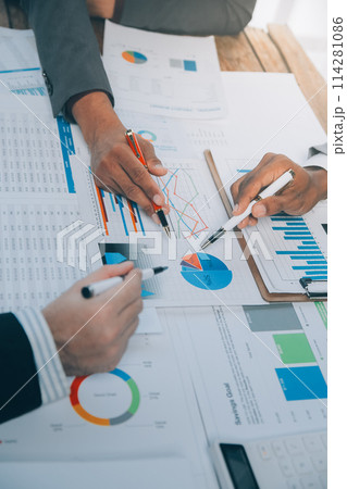 Business idea. Business people talking And calculations about charts and graphs showing the growth of investment results Of successful teamwork Business idea. Business people talking And calculations about charts and graphs showing the growth of investment results Of successful teamwork 114281086