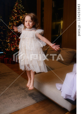 A happy family poses in pajamas in New Year's locations. A happy family poses in pajamas in New Year's locations. 114281643