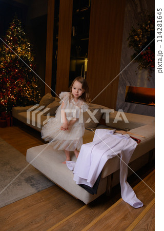 A happy family poses in pajamas in New Year's locations. A happy family poses in pajamas in New Year's locations. 114281645