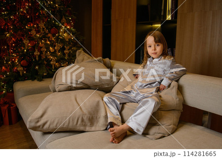 A happy family poses in pajamas in New Year's locations. 114281665