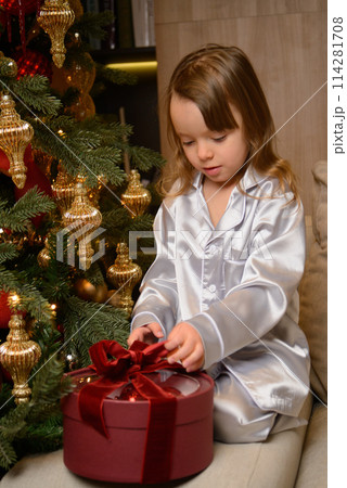 A happy family poses in pajamas in New Year's locations. A happy family poses in pajamas in New Year's locations. 114281708