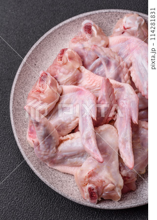 Fresh chicken wings with salt, spices and herbs Fresh chicken wings with salt, spices and herbs 114281831