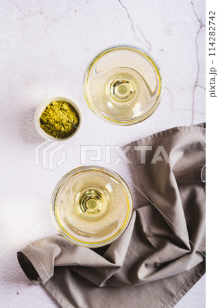 Refreshing green matcha martini in glasses on the table top and vertical view 114282742