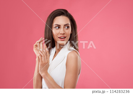 Shocked and surprised girl screaming covering mouth her hands.Beautiful Woman in black dress.Presenting your product.Expressive facial expressions emotions 114283236